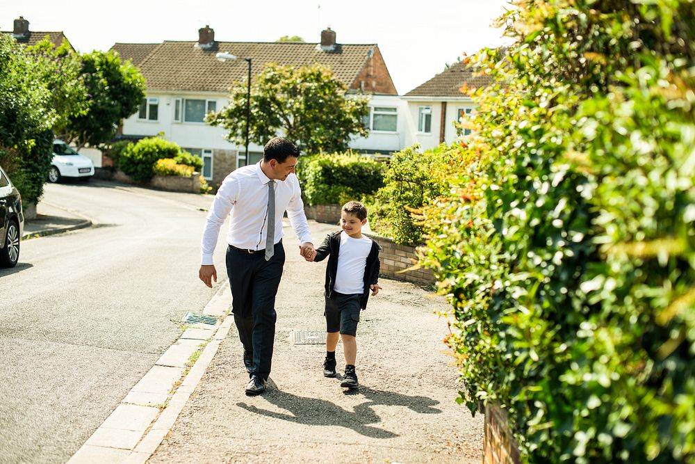 Father walking his son to school