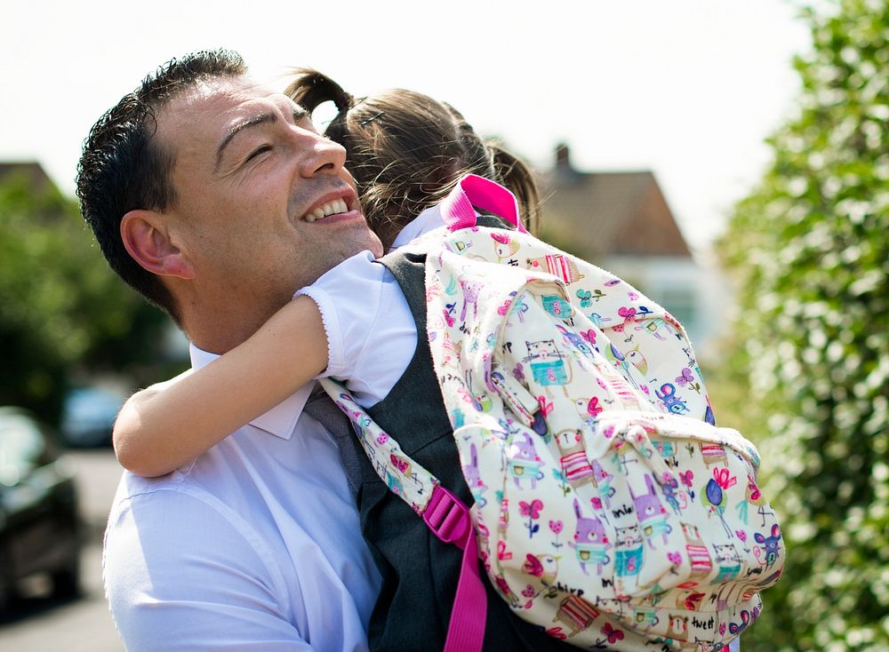 Father welcoming his daughter home from school