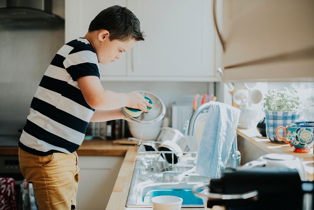 Little boy doing the dishes