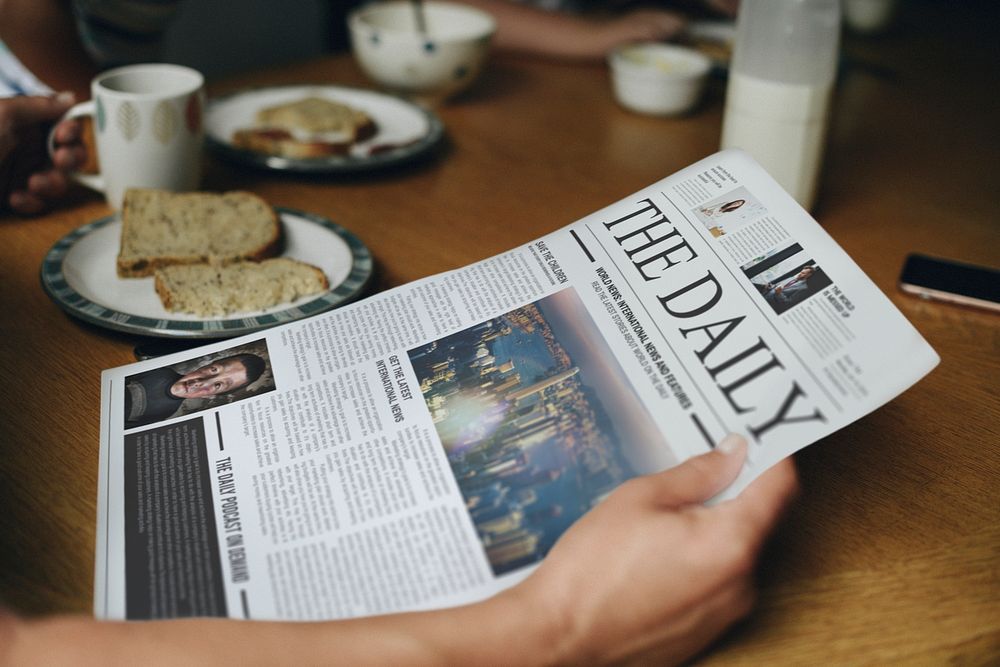 Man reading the news at the breakfast table