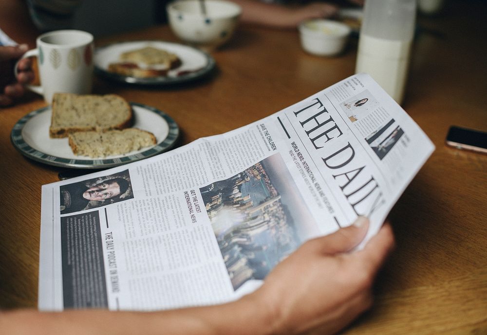 Man reading the news at the breakfast table