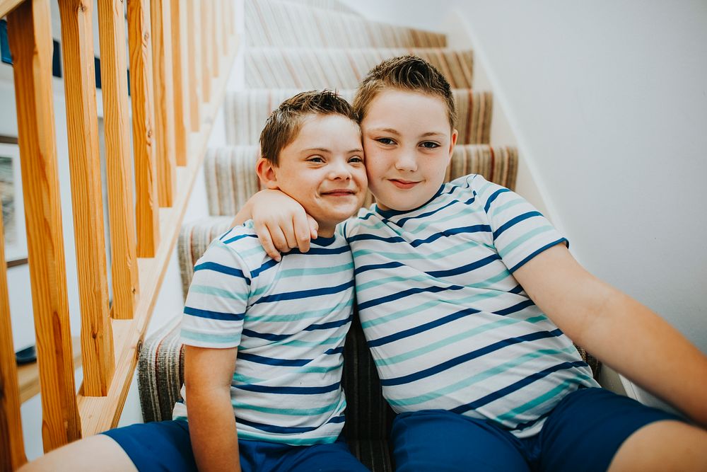 Brothers hugging at the stairs