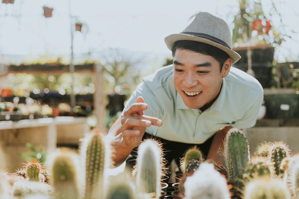 Cheerful man buying a cactus