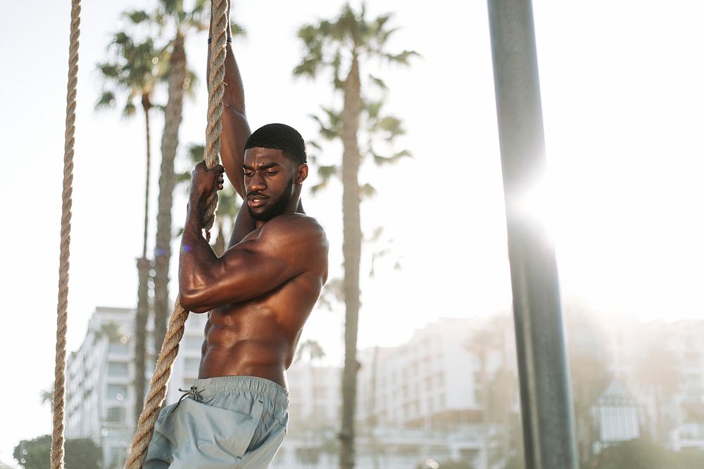 Fit man working out with ropes