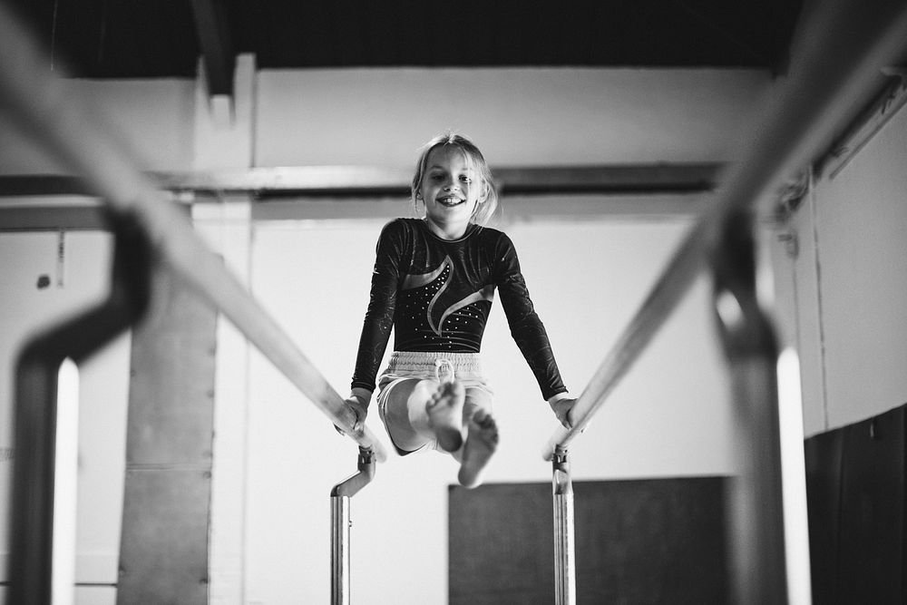 Young gymnast on parallel bars