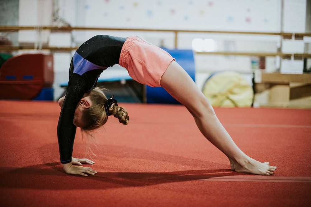 Young gymnast doing a bridge pose