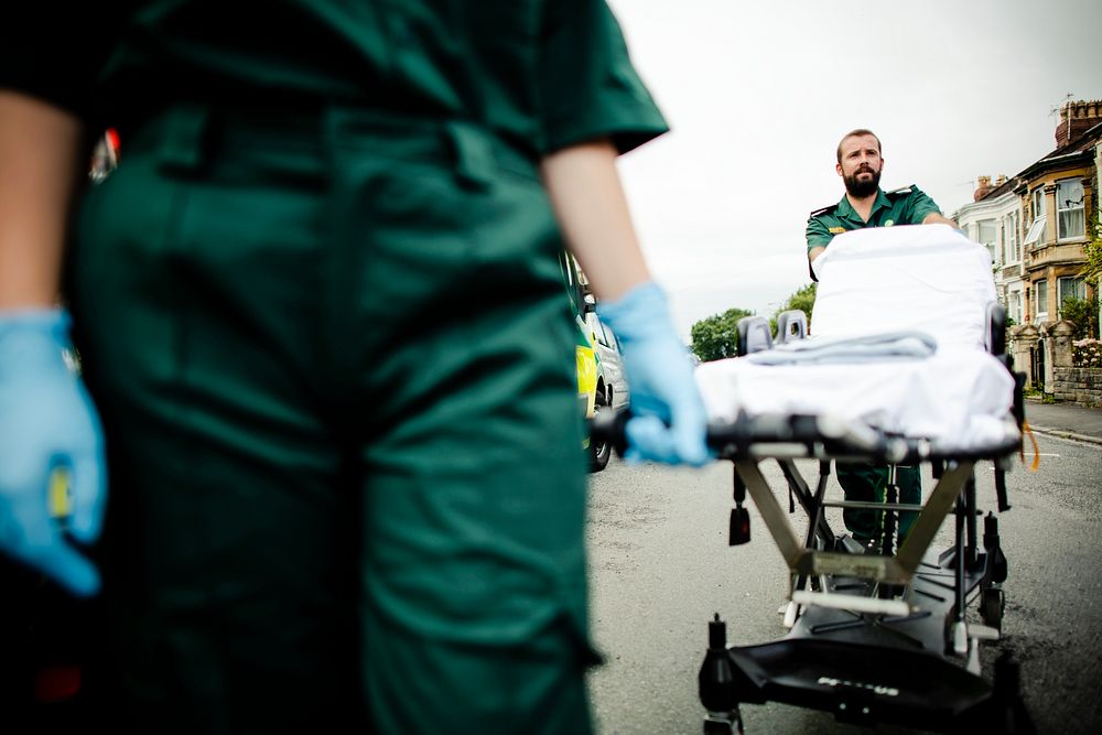 Paramedic team rolling a stretcher on a street