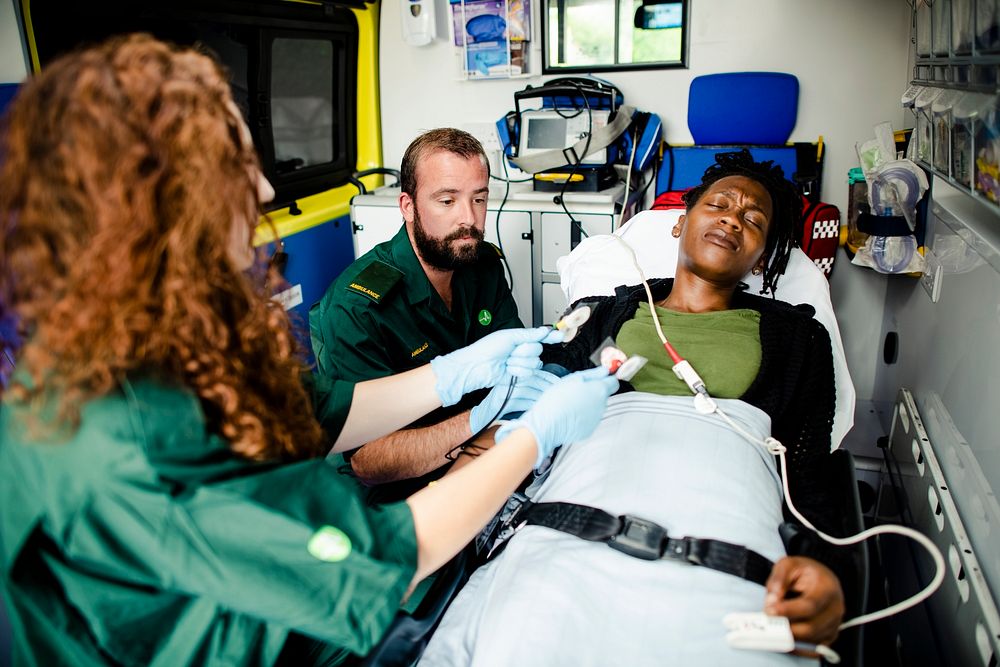 Paramedics providing first aid to a patient