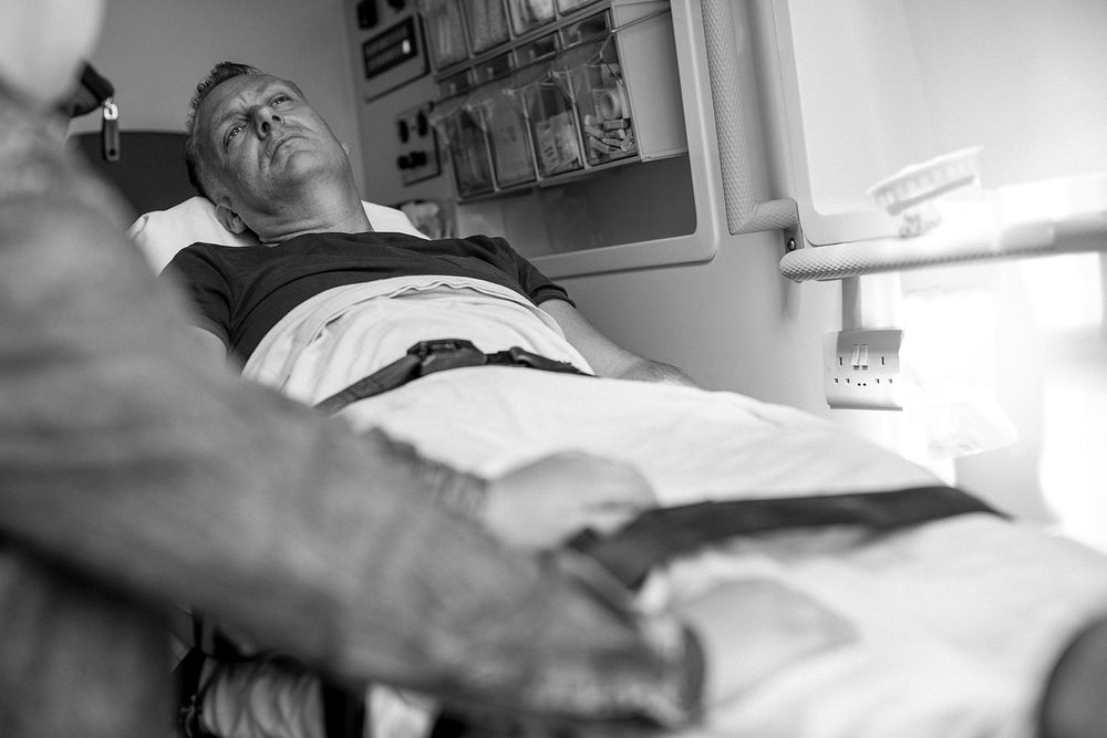 Worried patient lying on a stretcher in an ambulance
