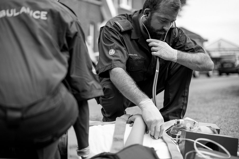 Paramedic team rescuing a young critical patient