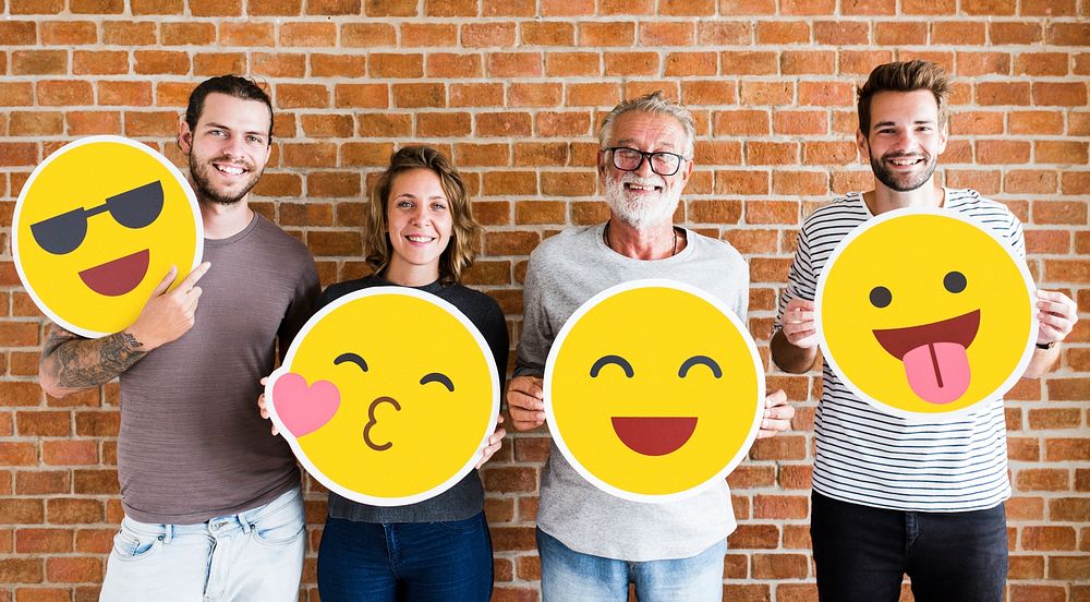 Happy people holding positive emoticons