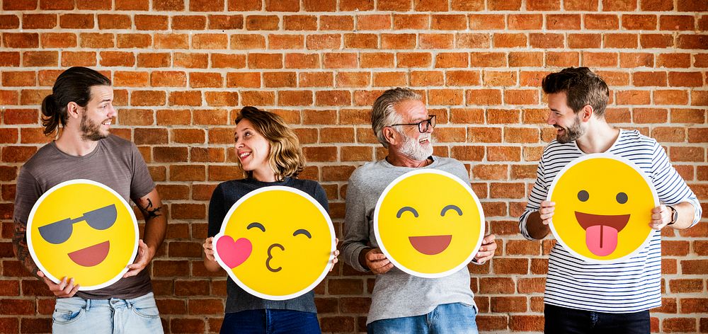Happy people holding positive emoticons