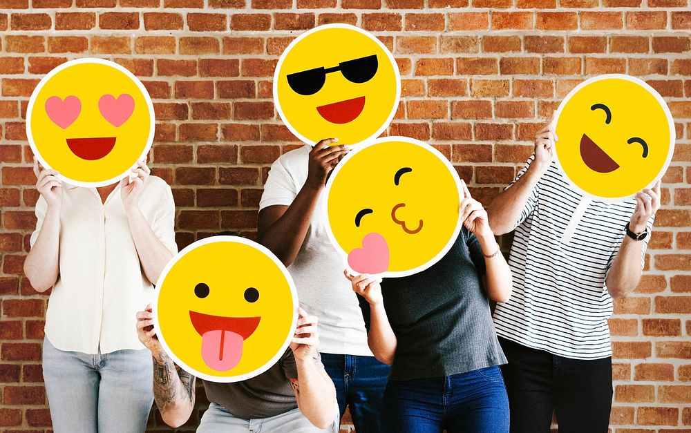 People holding positive emoticons