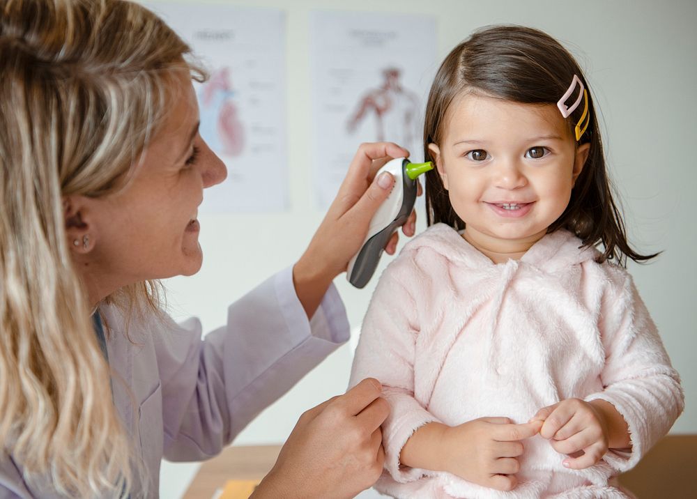 Otolaryngologist checking up on a sweet little girl