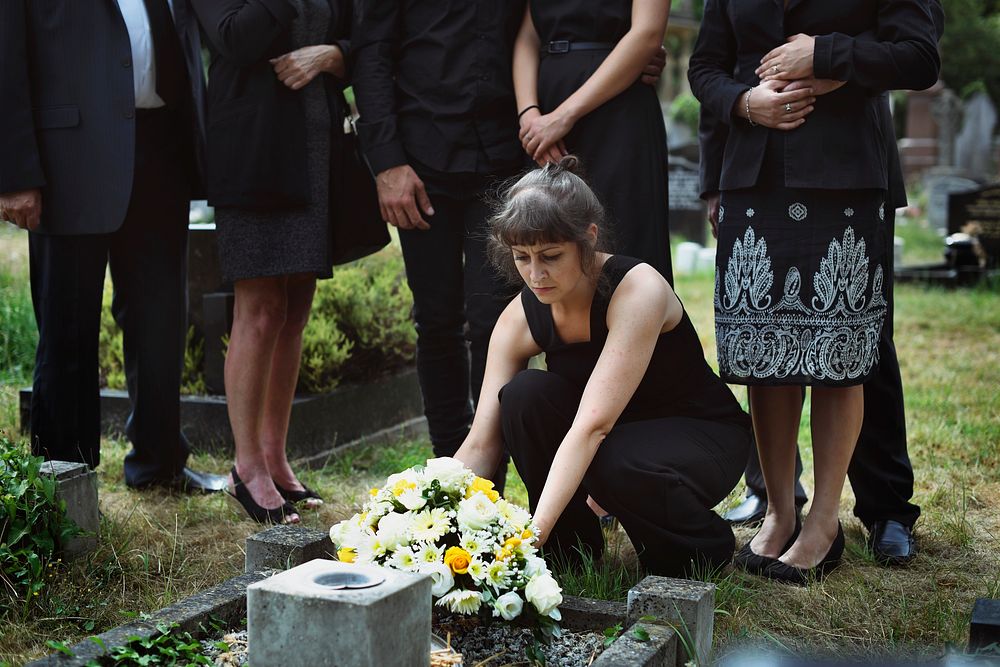Family laying flowers on the grave