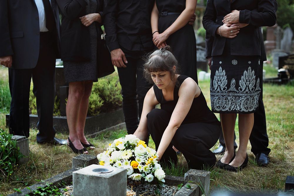 Family laying flowers on the grave | Premium Photo - rawpixel