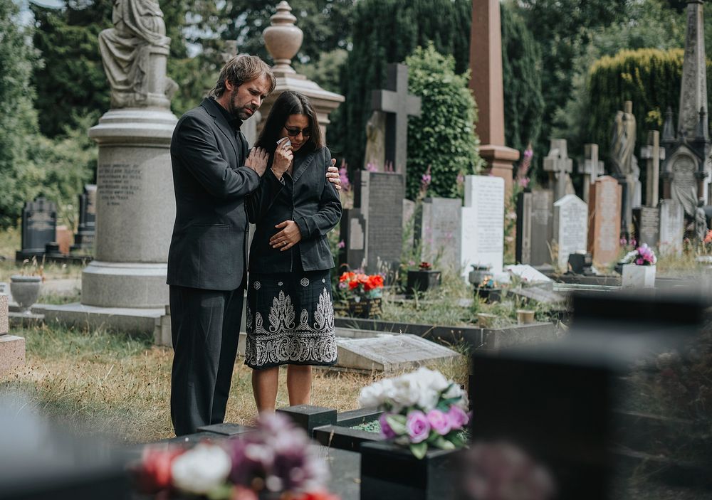 Couple giving their last goodbyes at the cemetery
