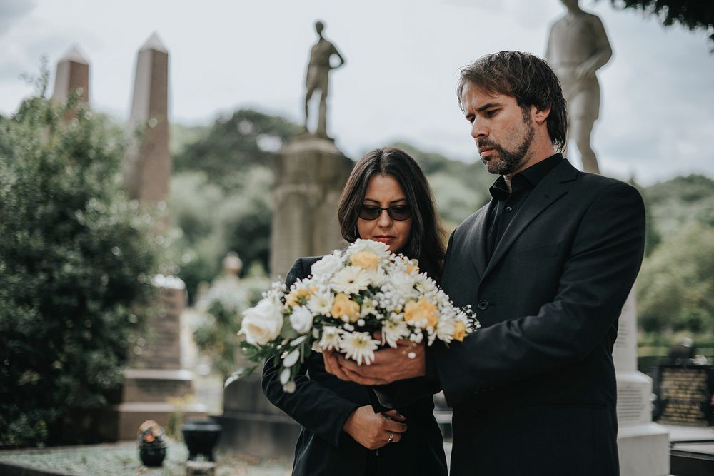 Couple grieving their loss at the cemetery