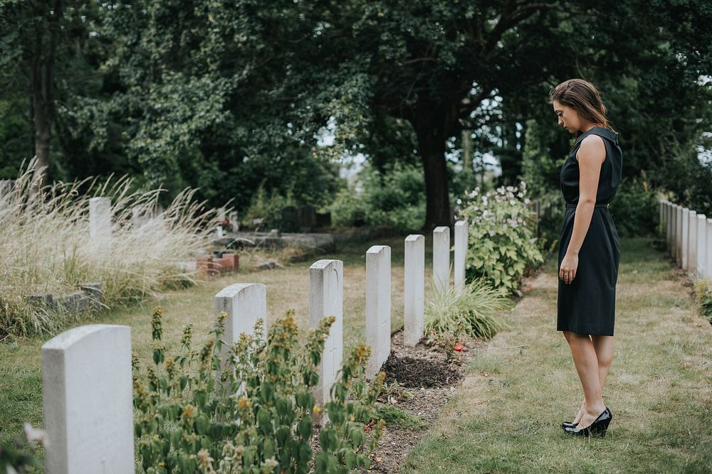 Young widow at a graveyard