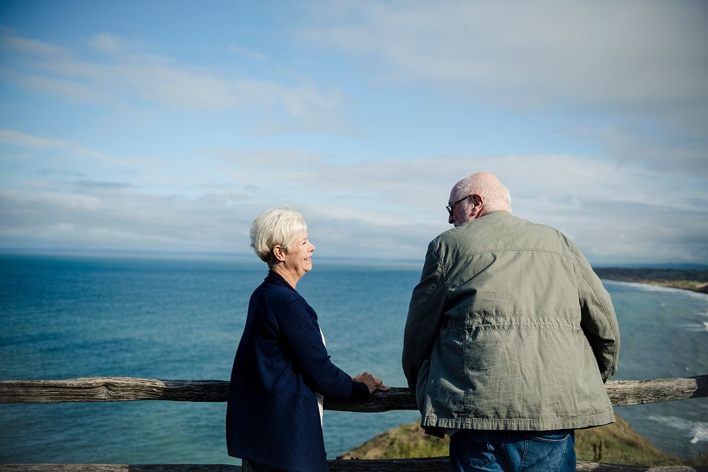 Happy senior couple enjoying the view of the ocean