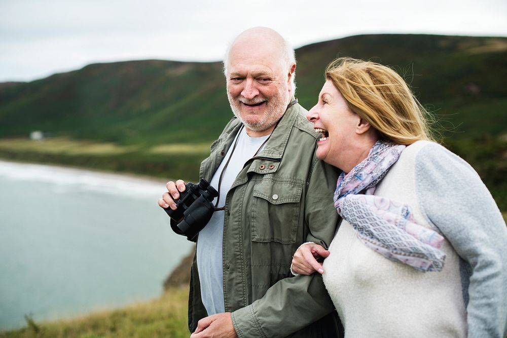 Happy senior couple enjoying with a pair of binoculars