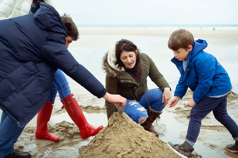 Happy family building a sand castle