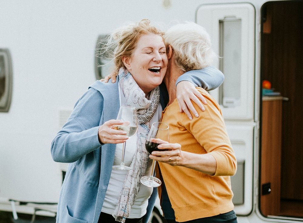 Happy senior women hugging each other