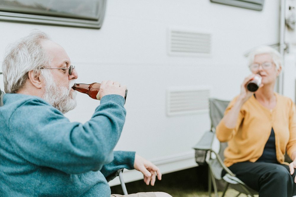 Senior people drinking a bottle of beer