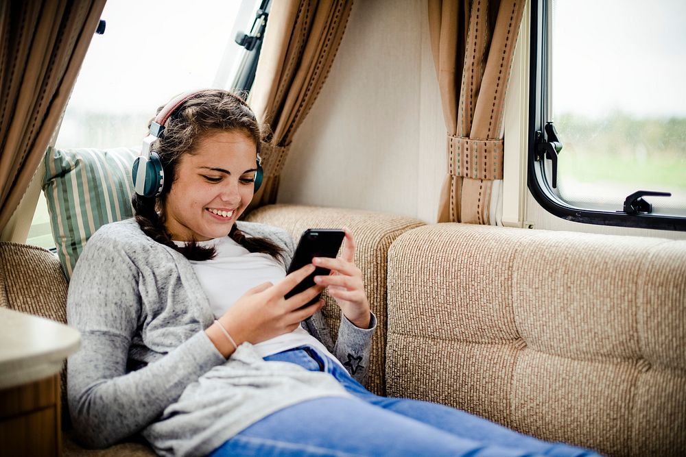 Happy girl with headphones enjoying her music