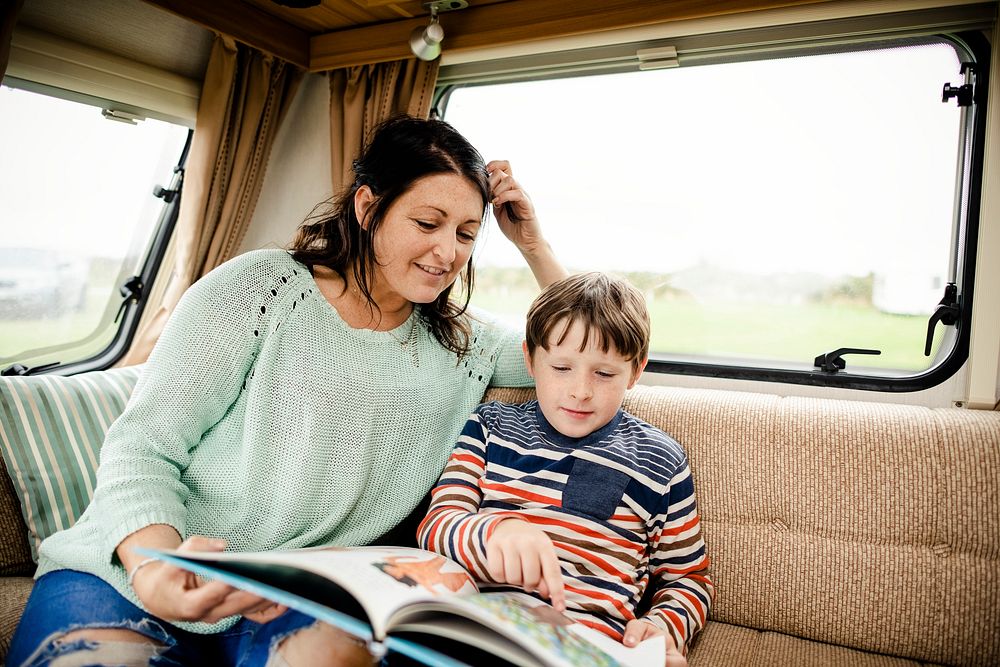 Mother helping her child read