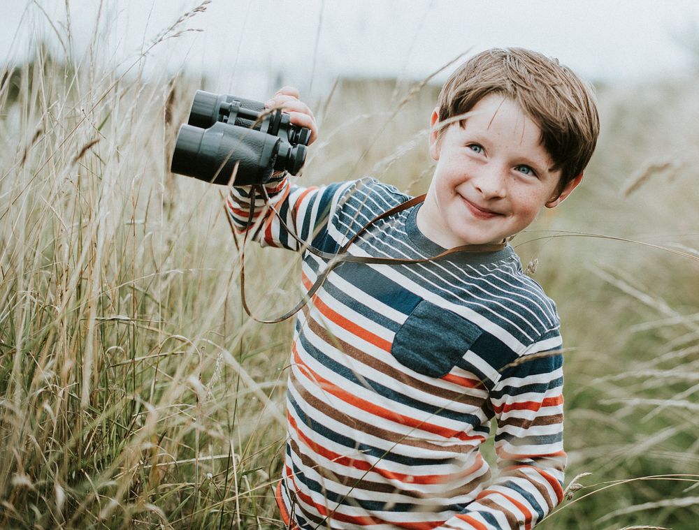 Happy young boy with a pair of binoculars
