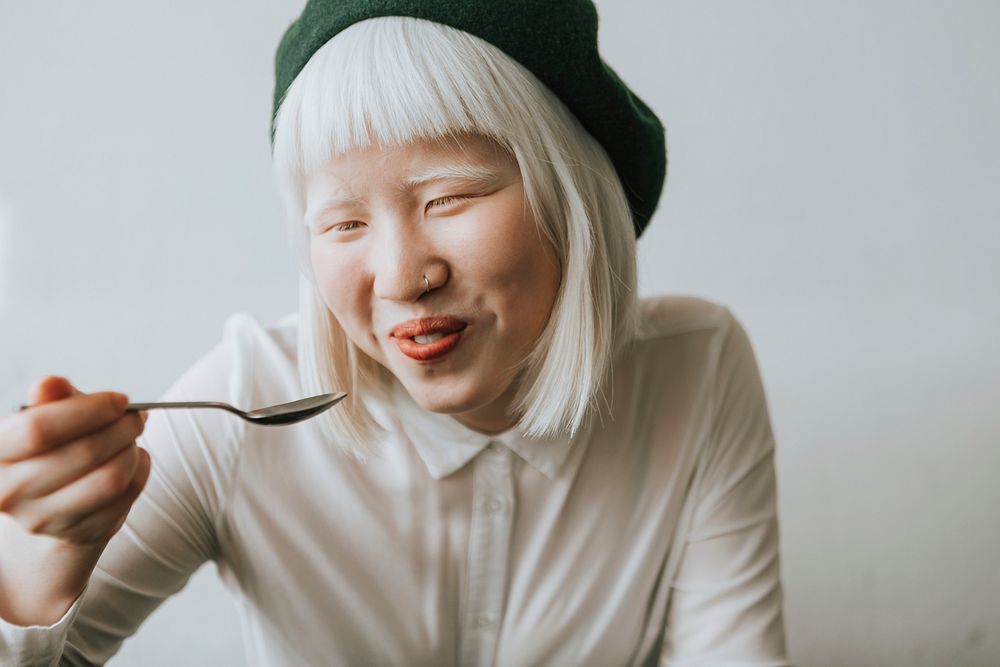 Cute albino girl having breakfast