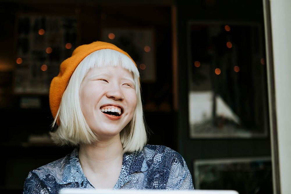 Portrait of a cute albino girl in an orange beret