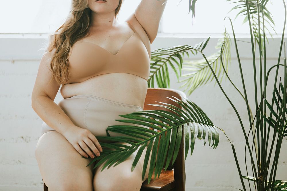 Beautiful and confident plus size woman in nude underwear