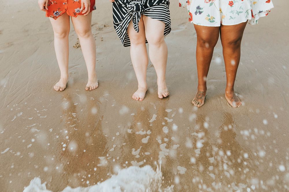 Diverse women soaking their feet in the water