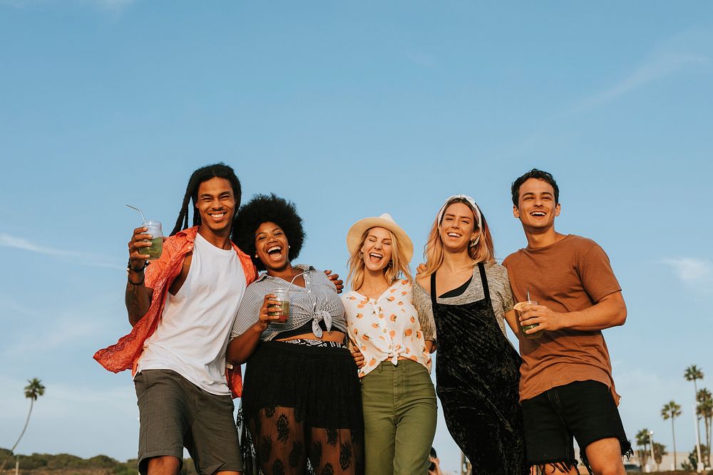 Group of diverse friends hanging out at the beach