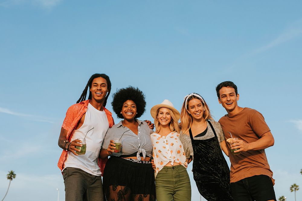 Group of diverse friends hanging out at the beach