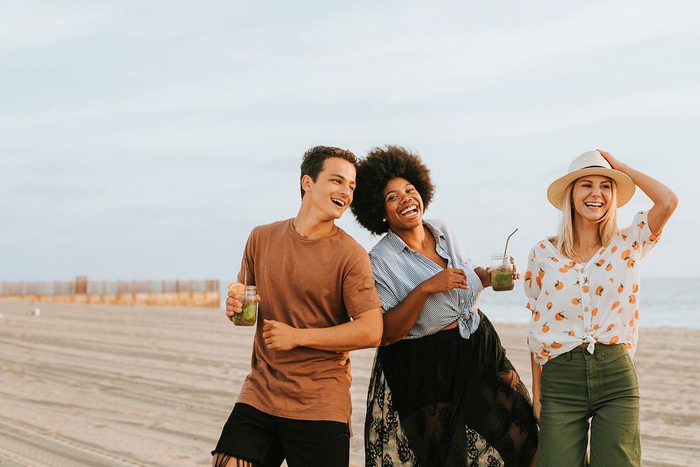 Friends dancing and having fun at the beach