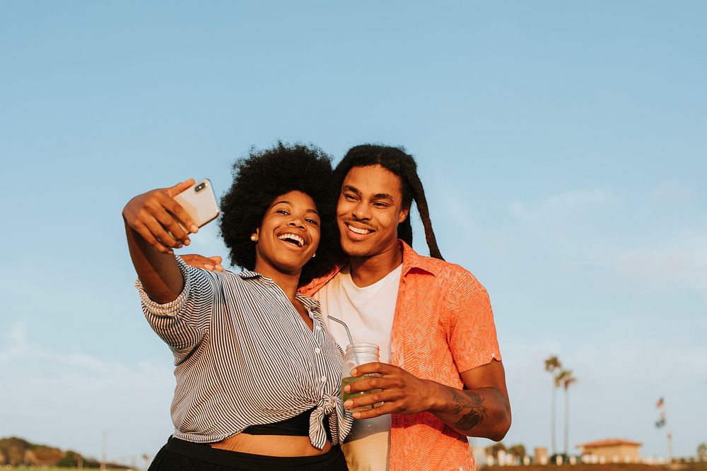 Lovely couple taking a selfie at the beach