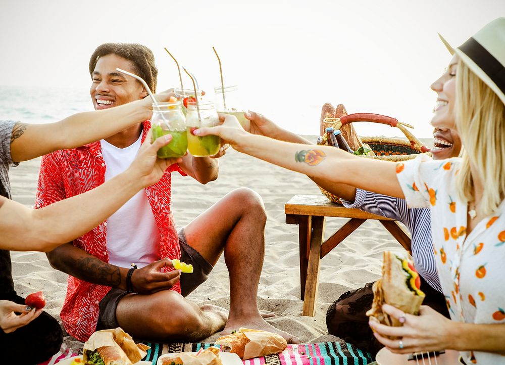 Diverse friends enjoying a beach picnic