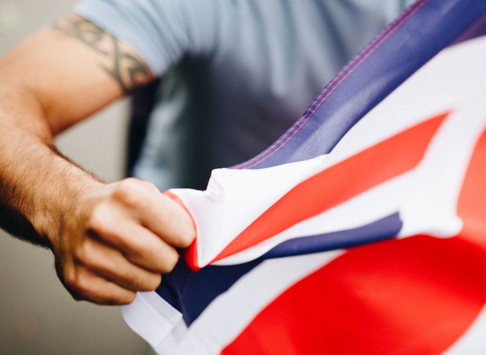Man showing his fist with UK flag during a protest