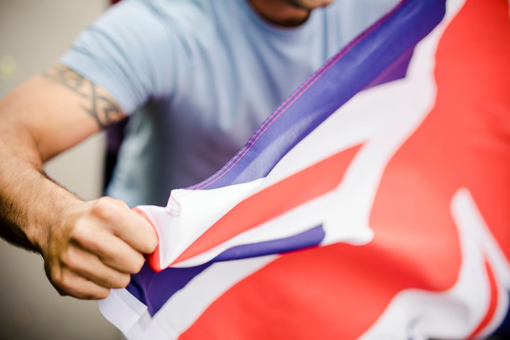Man showing his fist with UK flag during a protest