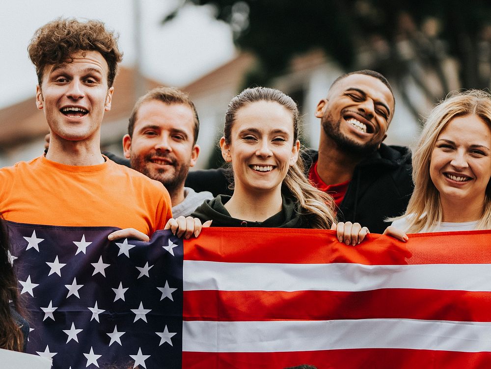 Group of young adults showing an American flag