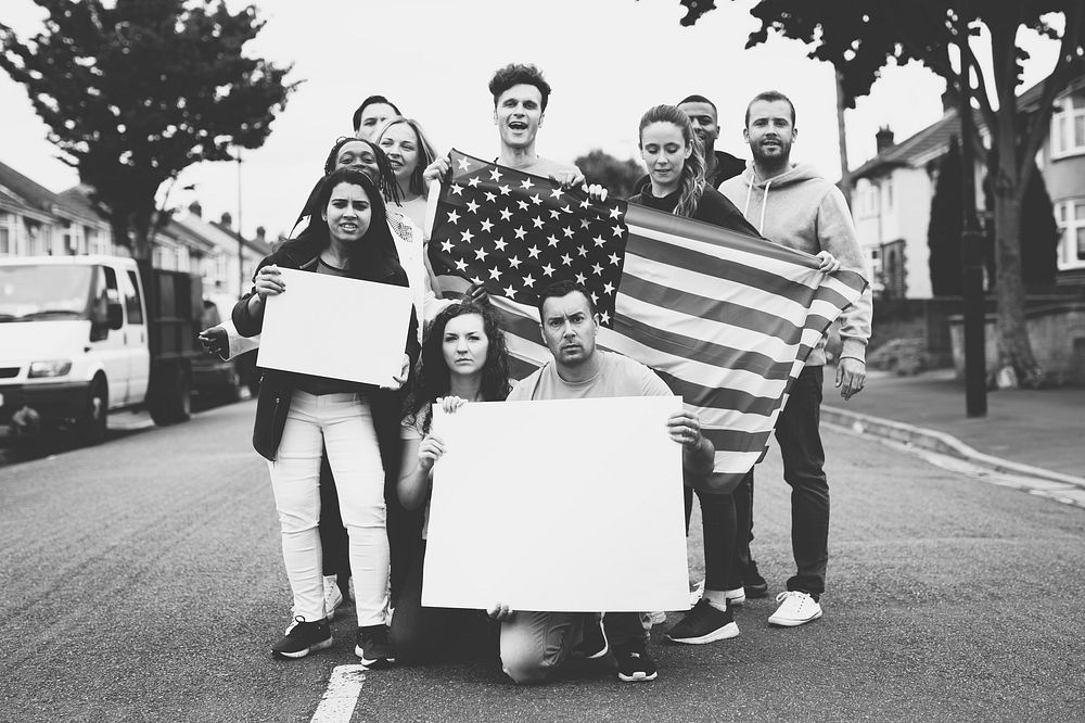 Group of activists showing American flag and blank posters