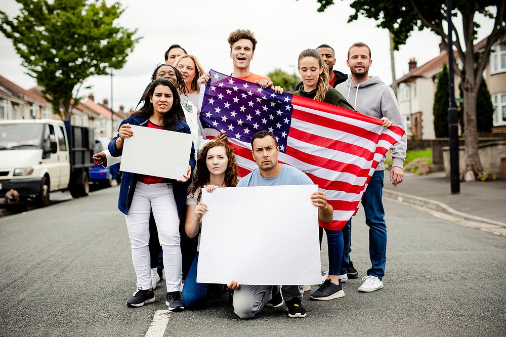 Group of activists showing American flag and blank posters