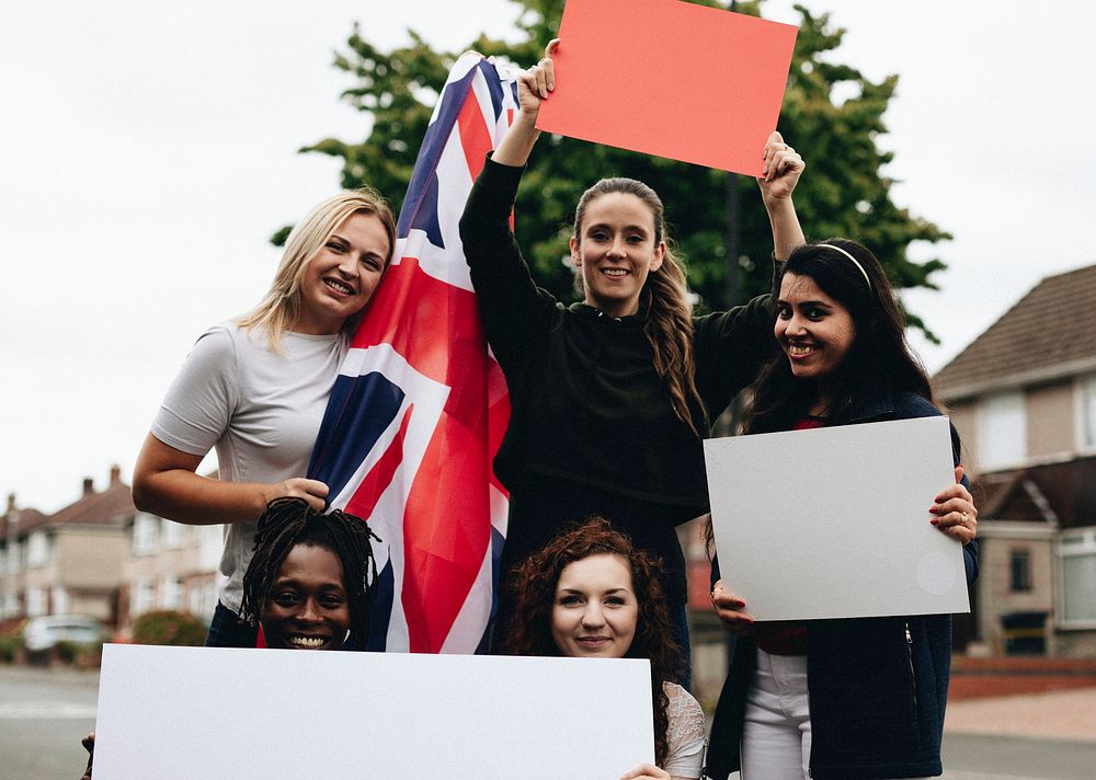 Group of women showing UK flag and blank boards