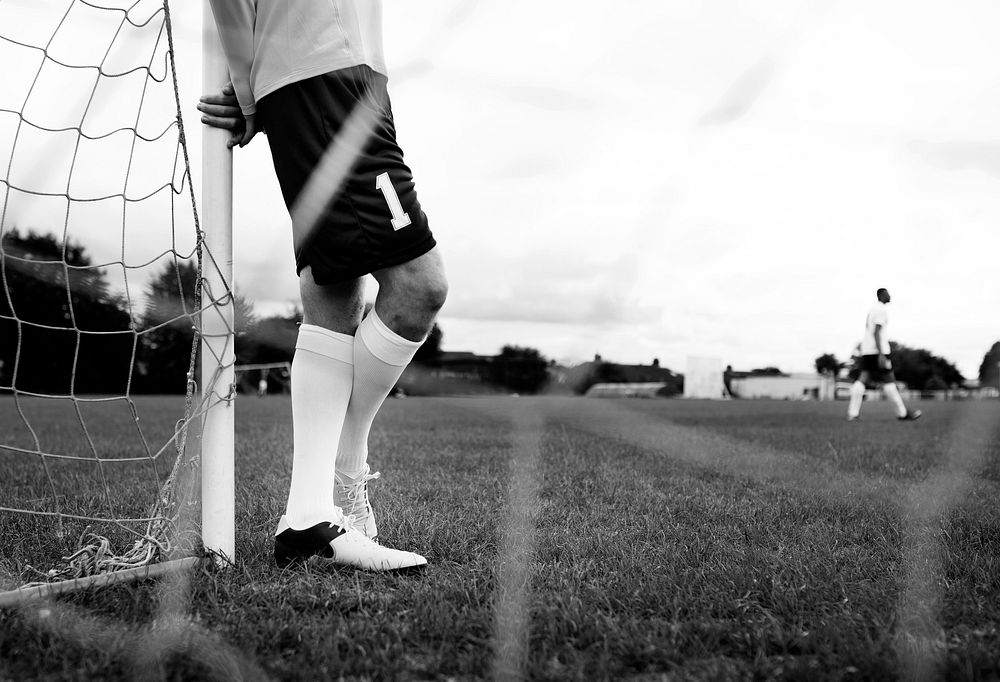 Male goalkeeper standing by the goal