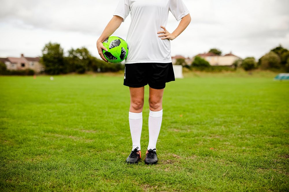 Female athlete holding a football