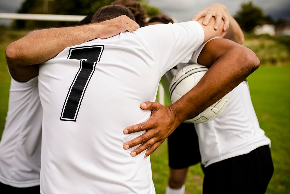 Football players huddling before a match