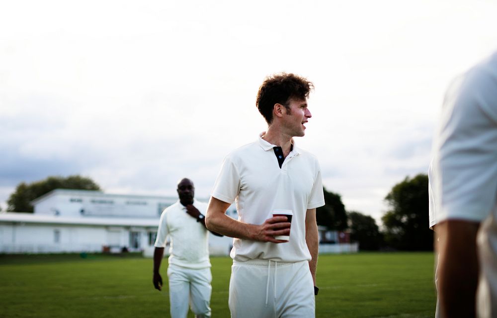 Cricket player holding a coffee paper cup